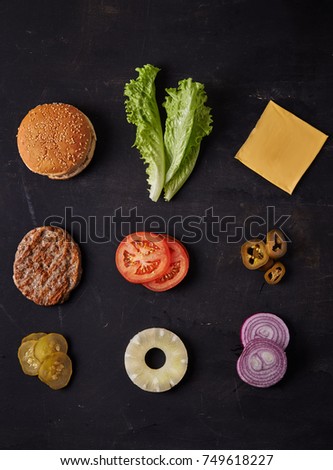 burger ingredients on dark background. top view Royalty-Free Stock Photo #749618227
