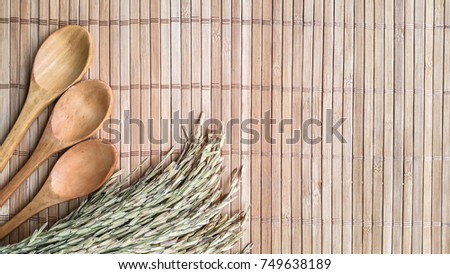 wooden spoon and ear of rice on the table background .