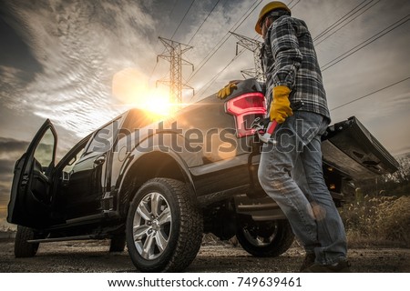 Contractor Field Research Future Construction Site. Field Work. Caucasian Worker and His Company Pickup Truck Royalty-Free Stock Photo #749639461
