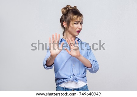 It's not that. Shocked young adult blonde woman posing on gray background. Isolated, studio shot