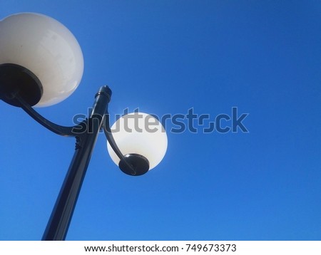 A street lamp with a blue sky background