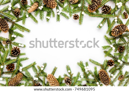 Frame made of Christmas composition with fir branches, pine cones on white background. Flat lay, top view holiday decoration concept.
