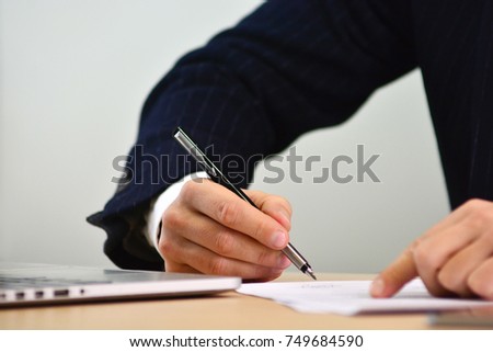 Elegant boss signs a paper contract. Concept of business.