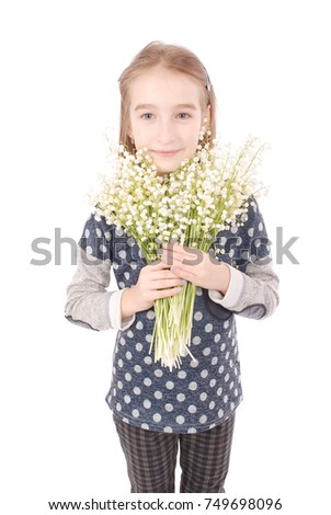 Portrait of a happy pretty girl holds a flower of a lily of the valley. Isolated on white background.