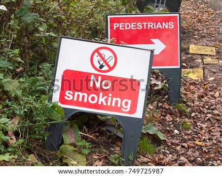 no smoking warning plastic sign floor road pedestrians direction; essex; england; uk