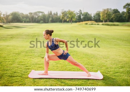 Young beautiful girl doing yoga outdoors
