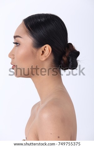 Asian Woman after applying make up wrap hair style. no retouch, fresh face with acne wart. Studio lighting white background, rear side back view