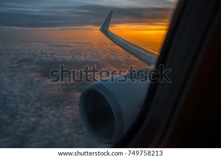 Wing of an airplane in the morning sunrise. Picture for add text message or frame website. Photo taken in the sky.