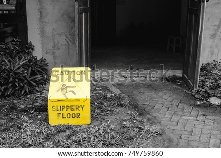 Yellow slippery floor sign on the ground, single color (yellow) in monochrome toning