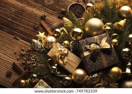 Golden Christmas decorations on a rustic wooden table. Place for typography.