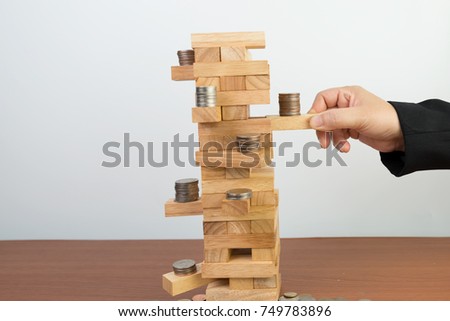 hand of businesswoman pulling out or placing wood block isolated on white background,Planning, risk and strategy in business, investment, finance