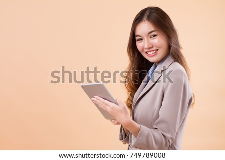 portrait of happy asian business woman using computer tablet