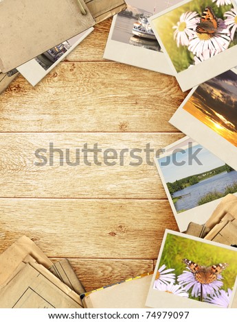 Frame with old paper and photos. Objects over wooden planks