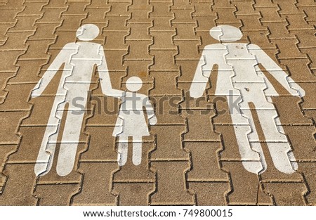 Family sign on the pavement in a carpark parking spot