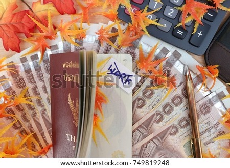 No work just travel, passport open with cross on work as no sign and calculator with pen on pile of money decorated with plastic orange tone maple leaves 
