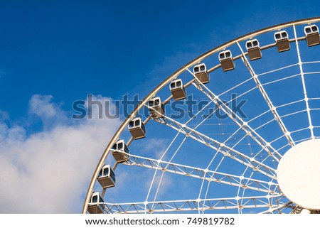 Closeup part of ferris wheel over the blur sky