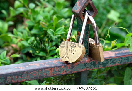 Padlock and heart as symbol of love with text about love in Paris