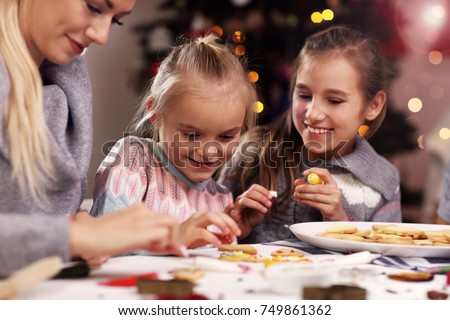 Picture showing joyful family preparing Christmas biscuits