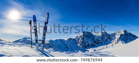 Ski in winter season, mountains and ski touring backcountry equipments on the top of snowy mountains in sunny day. South Tirol, Solda in Italy. Royalty-Free Stock Photo #749876944