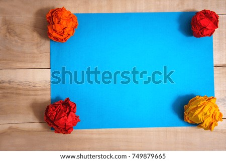 paper blue with balls of paper on a wooden table