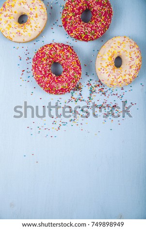 Multicolored donuts close-up on a wooden background. Delicious dessert.