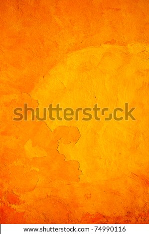 Orange wall with cracks and peeling paint. Royalty-Free Stock Photo #74990116