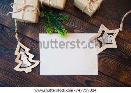 Stylish branding mockup to display your artworks. Cute vintage christmas new year gifts, star, tree mock up on wooden background.