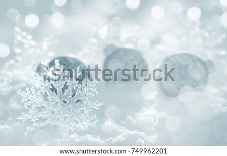Christmas background with decorative snowflake and balls in the snow