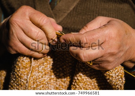 The hands of a grandmother knitting