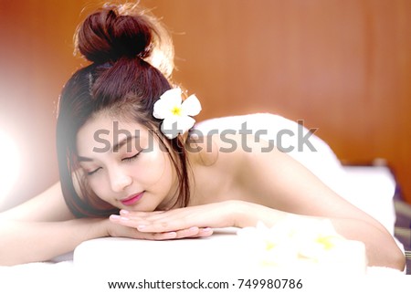 An attractive young Asian woman enjoying a relaxing massage at the spa