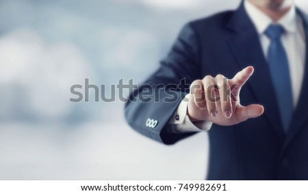 Businessman hand touching virtual screen, modern background concept , can put your text at the finger, copy space Royalty-Free Stock Photo #749982691