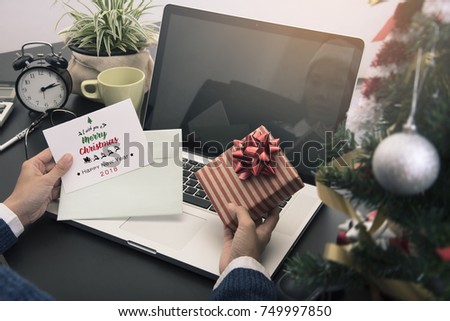 People received greeting card text massage Merry Christmas and present gift  from another person.