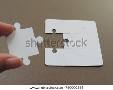 Pieces of jigsaw puzzles connected unsuccessfully,Selective focus image.