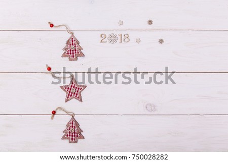 Concept christmas background with decorations, xmas tree and gift boxes on white wooden board. New year card. Empty space for your text. Sigh symbol from number 2018