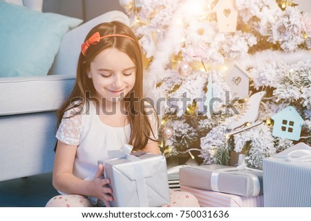 Presents Christmas time. Opening the box beautiful kid girl.Happy New year moment. 