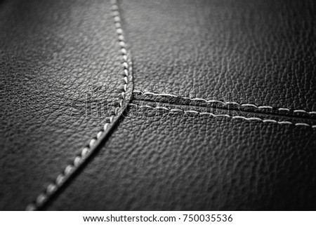 Texture of grey leather background with stitched seam, close-up. Texture for design.
