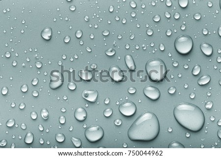 Drops of water on a color background. Gray. Toned.