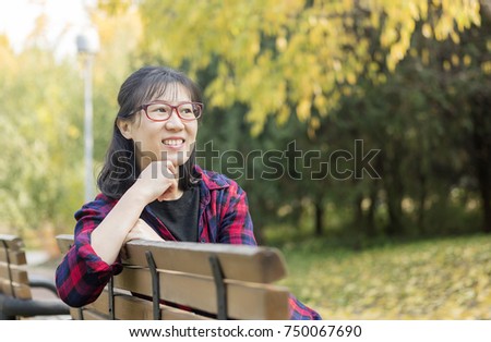 Beautiful and generous Asian women in autumn Parks