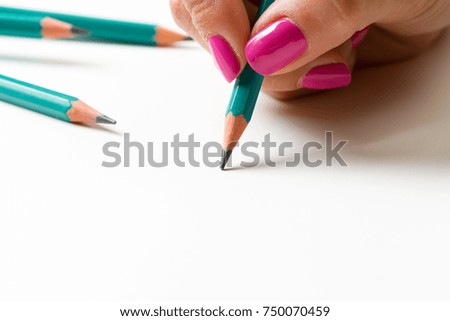 Woman's hand with a pencil