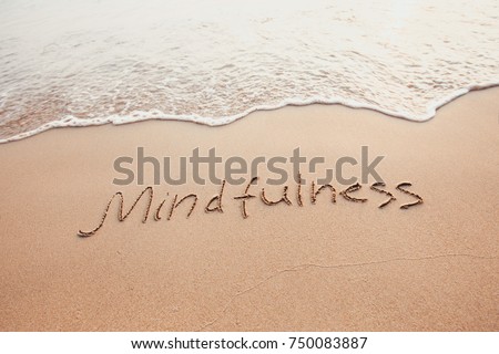 mindfulness concept, mindful living, text written on the sand of beach Royalty-Free Stock Photo #750083887
