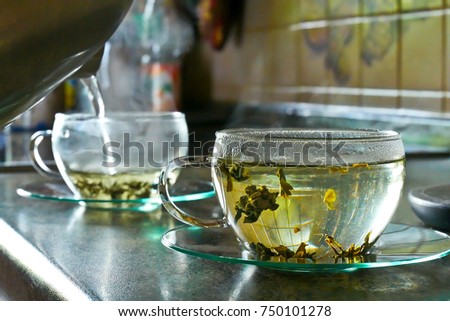 Pouring Hot Water into the Cup of Tea