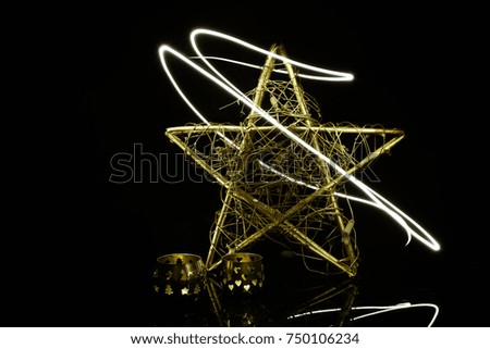 Shiny christmas gold star ornament on white background with flash.