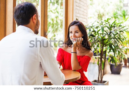 woman looking at the man on a date in cafe Royalty-Free Stock Photo #750110251