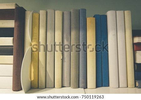 Book stacks in the room.shallow depth of field.low light and grain effect