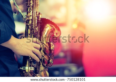 World Jazz festival. Saxophone, music instrument played by saxophonist player musician in fest. Royalty-Free Stock Photo #750128101