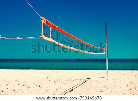 Summer beach life concept - Volleyball net and empty beach. Sea Beach and Soft wave of blue ocean.