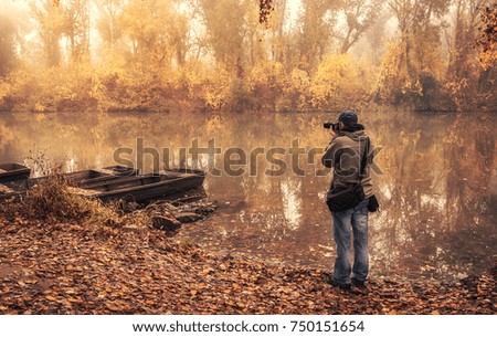 Landscape photographer take a picture  in the park an autumn day