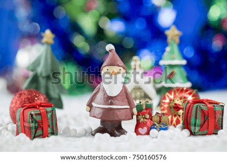 Santa claus Standing with Gift Box on bokeh background. Christman Concept.