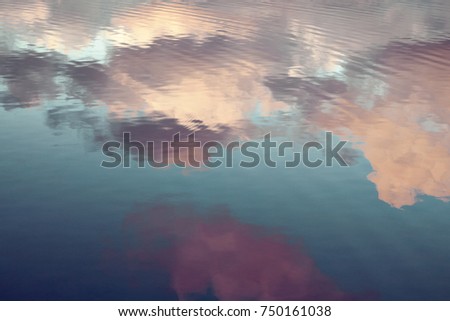 reflection of blue sky with white clouds in water, abstract background. Royalty-Free Stock Photo #750161038