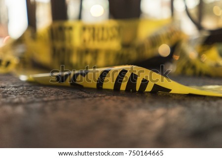 Police Line Do Not Cross Tape On The Ground Royalty-Free Stock Photo #750164665